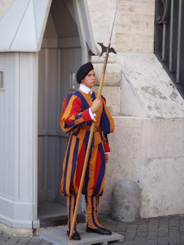 Swiss Guard in vibrant uniform holding halberd at Vatican City.